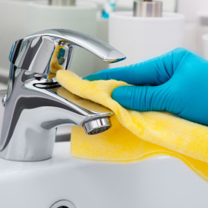 Die Armatur eines Waschbeckens bei der Unterhaltsreinigung